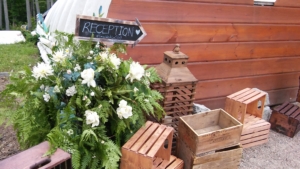 Flowers and display set up with an arrow sign that says 'Reception'.